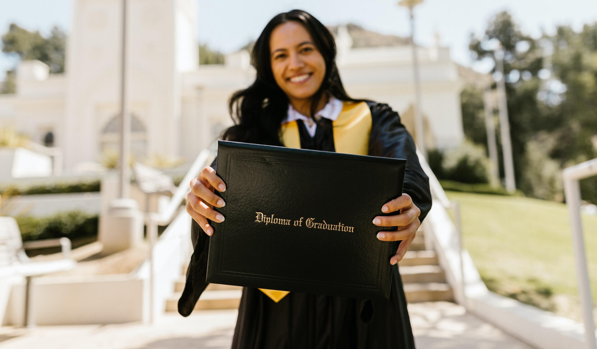 Graduate showing diploma Graduate showing diploma